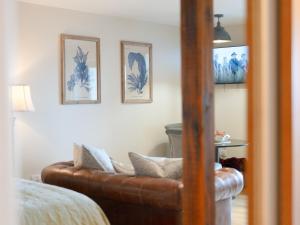 a living room with a brown leather couch at Skye Studio - Ukc6566 in Mallaig