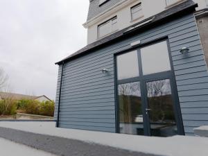 a gray garage with a large glass window at Skye Studio - Ukc6566 in Mallaig