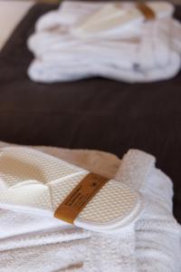 a pair of towels sitting on top of a bed at Castello Antico Hotel in Gythio