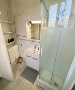 ein Bad mit einer Dusche und einem Waschbecken in der Unterkunft La Vague Dorée - Hyper-Centre - 15 min de Rouen in Barentin