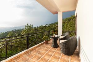 a balcony with a view of the mountains at Maple Resort Chail in Shimla