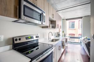 a kitchen with a sink and a microwave above a stove at Downtown Studio w Gym WD walkable location SEA-47 in Seattle +11 photos