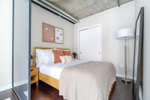 a bedroom with a bed and a large window at Downtown Studio w Gym WD walkable location SEA-47 in Seattle