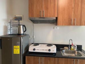 a kitchen with a toaster on a counter next to a sink at Studio unit at The Loop in Cagayan de Oro