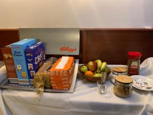 a table topped with food and a bowl of fruit at Jini Hotel in Blackpool