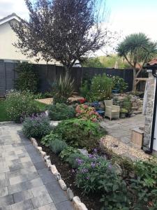 a garden with flowers and plants in a yard at The Old Police House in Cheddar