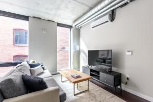 a living room with a couch and a tv at Downtown Studio w Gym WD walkable location SEA-47 in Seattle