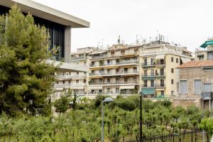 a view of a building with trees in front of it at Impressive Minimal 2 bdrm next to Acropolis Museum in Athens