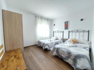 Postel nebo postele na pokoji v ubytování Apartamentos El Pozo