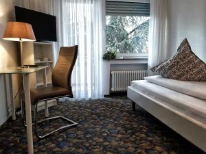Postel nebo postele na pokoji v ubytování Apart Hotel Freiburg