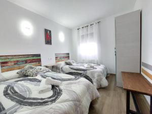 Postel nebo postele na pokoji v ubytování Apartamentos El Pozo
