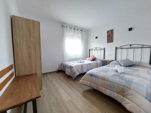 Postel nebo postele na pokoji v ubytování Apartamentos El Pozo