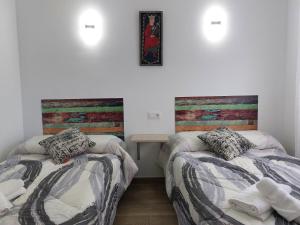 Postel nebo postele na pokoji v ubytování Apartamentos El Pozo