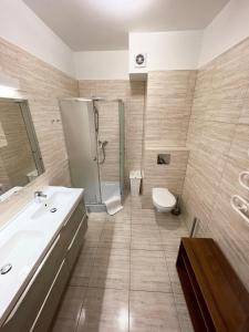 a bathroom with a sink and a toilet and a shower at Klimatyzowany apartament z basenem i garażem Willa 4 Pory Roku in Jastrzębia Góra