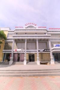 a building with a sign on the front of it at HOTEL UZBEGIM in Urganch