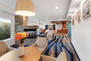 a living room with a table and a fireplace at Fairfield by Marriott Inn & Suites San Francisco Pacifica in Pacifica