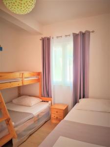 a bedroom with two bunk beds and a window at Apartment in Murter in Murter