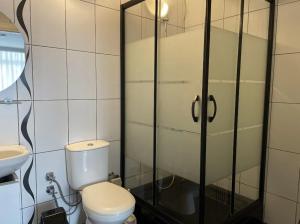 a bathroom with a toilet and a sink at Poyraz Resort in Marmaraereglisi