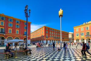 a group of people walking around a city square at Aparthotel AMMI Nice Lafayette in Nice