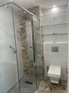 a bathroom with a shower and a toilet at APPARTEMENTS NIA CONFORT, Plein centre ville, avec TERRASSE in Fès +19 photos