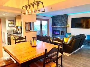 a dining room and living room with a wooden table at Stylish 2BR Condo Near Olympic Park and Ski Resorts in Park City