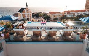 a view from the balcony of a resort with a pool at Elements Hotel & Shops Curaçao in Willemstad