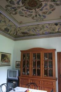 a room with a china cabinet and a ceiling at Villino Oliva in Pomonte