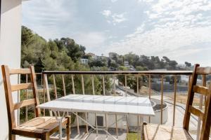 a balcony with a table and chairs and a view at Private room in renovated apartment - Tram 1 min walk in Nice
