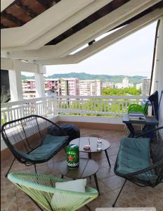 a patio with chairs and tables on a balcony at Apartment 075 in Tuzla