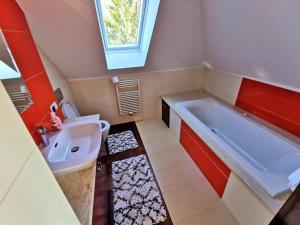 a bathroom with a large tub and a sink at Domek wypoczynkowy Zielonka z JACUZZI in Szczytno