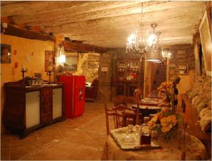 a kitchen and a living room with a red refrigerator at El Callejon De Andrese in Loarre