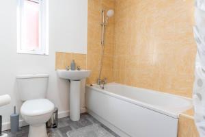 a bathroom with a toilet and a sink and a bath tub at Entire House with 3 bedrooms in Liverpool
