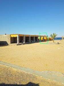 an empty beach with a playground in the background at Musa Camp in Nuweiba