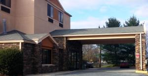 a building with a stone archway next to a building at Baymont by Wyndham Newark at University of Delaware in Newark