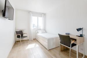 a room with a bed and a desk and a tv at Private room in renovated apartment - Tram 1 min walk in Nice