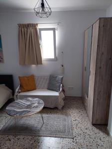 a living room with a couch and a window at Explore Greece from Cozy City Centre Apartment in Chalkida