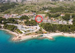 an aerial view of a beach with a clock on it at Beachfront XXL - 2 Apartments Together - in Lokva Rogoznica