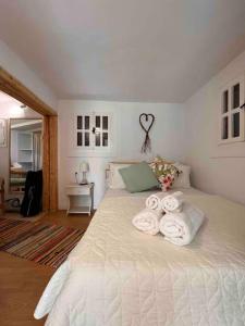 a bedroom with a bed with towels on it at Under the vine garden house in Platánion