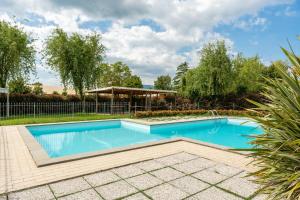 a swimming pool in a yard with a fence at Casolare dei Fiori - Calla in Montecarlo