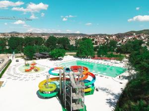a water park with a water slide and a pool at Oaza Hotel in Štip