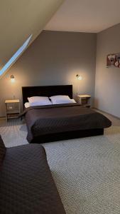 een slaapkamer met een groot bed met 2 tafels en 2 lampen bij Hotel Zdrojewo in Nowe