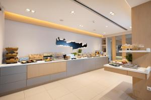 a restaurant kitchen with a counter with food at Lamon Hotel in Plakias