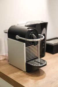 a coffee maker sitting on top of a table at JAWO Apartments Koblenz modern & zentral in Koblenz