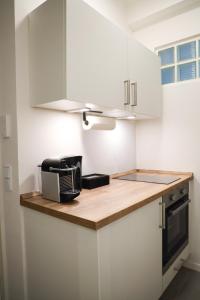 a kitchen with a counter with a toaster and a microwave at JAWO Apartments Koblenz modern & zentral in Koblenz