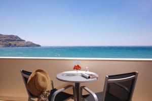 a table and chairs with a view of the ocean at Lamon Hotel in Plakias