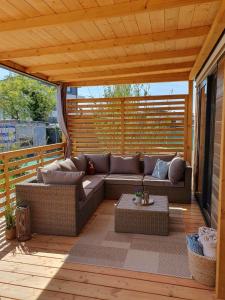 un patio con sofá y una mesa en una terraza en Mobile Homes Karlo & Dino, en Pula