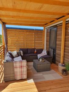 a screened in porch with a couch and a table at Mobile Homes Karlo & Dino in Pula