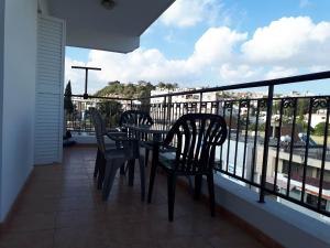 two chairs and a table on a balcony with a view at Amelia Two Bedroom Apartment - 201 in Paphos City