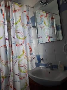 a bathroom with a shower curtain and a sink at Amelia Two Bedroom Apartment - 201 in Paphos City