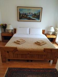 a bedroom with a large bed with two tables at B&B I FILOKSENIA in Trieste